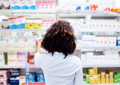 woman looking at products in a pharmacy